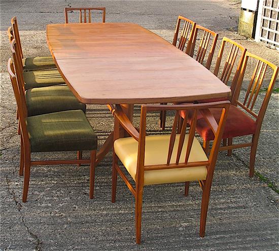 Gordon Russell, extending teak dining table with ten chairs including two carvers W.230cm